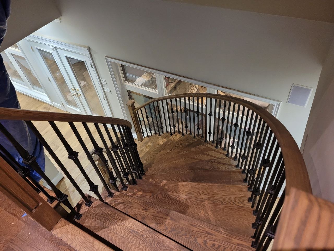 Hardwood curved staircase with iron balusters